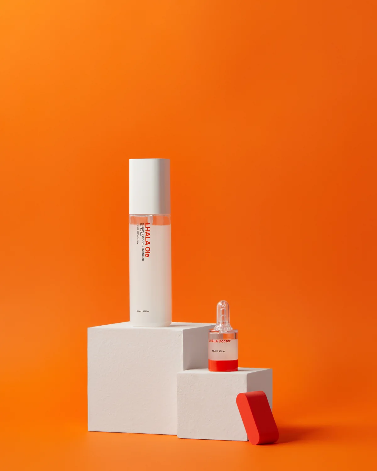 LHALA Ole and a LHALA Doctor ampoule on the brand orange